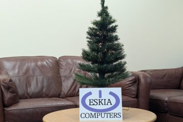 A Christmas Tree with the Eskia Logo in front of it